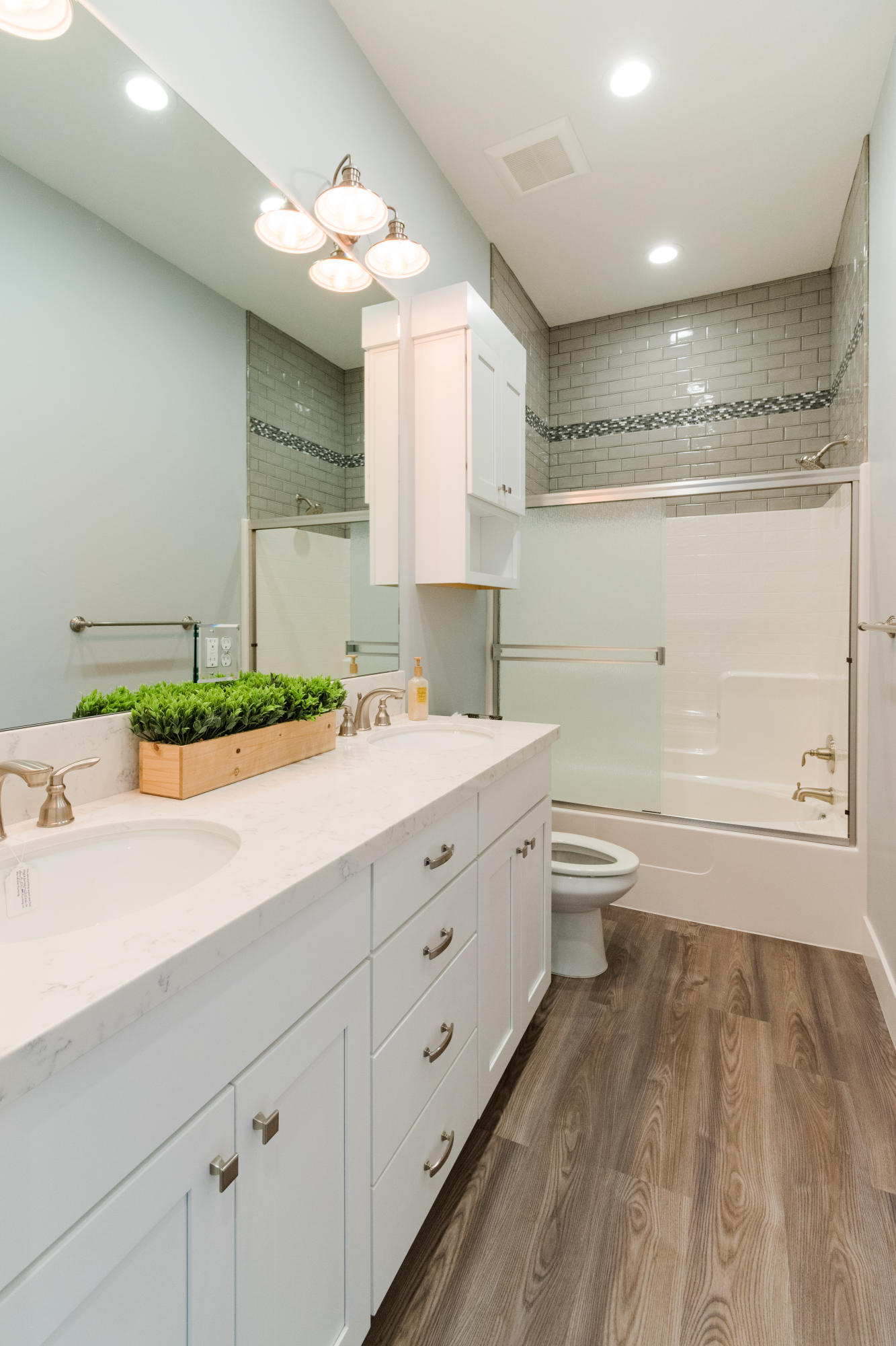 808 River Bend Road Redding, CA 96003 - Photo 26 of 43 a bathroom with a double vanity sink a toilet and a mirror