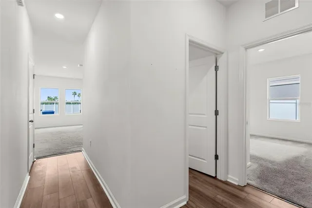 a view of hallway with wooden floor