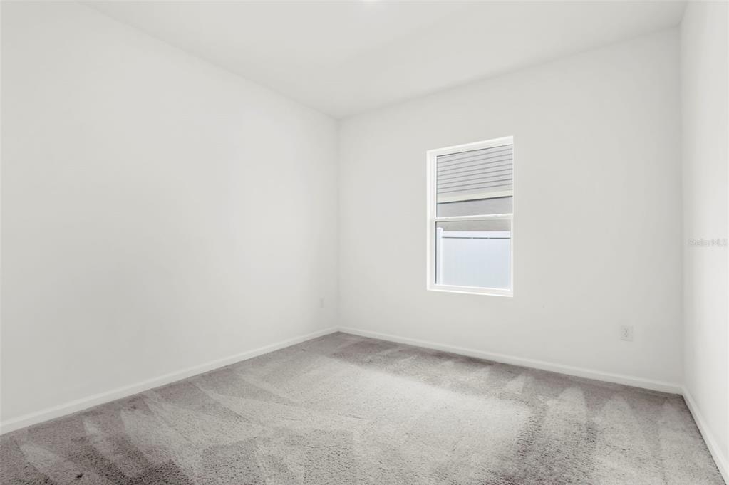 1038 Kelly Fern Loop Ruskin, FL 33570 - Photo 14 of 34 an empty room with a window