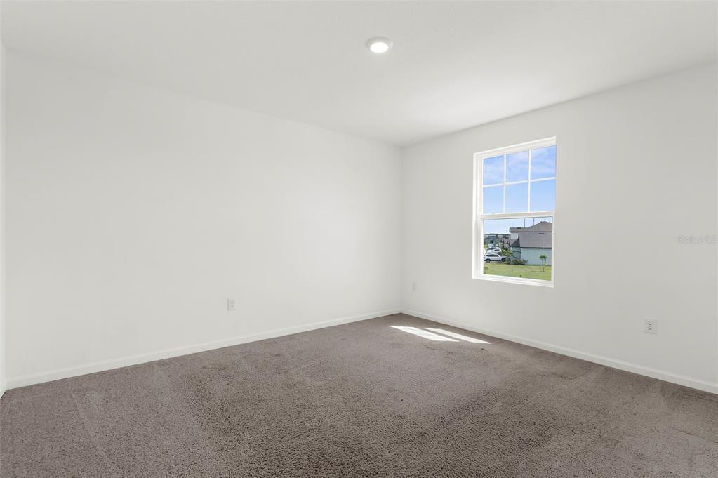 1038 Kelly Fern Loop Ruskin, FL 33570 - Photo 26 of 34 an empty room with windows