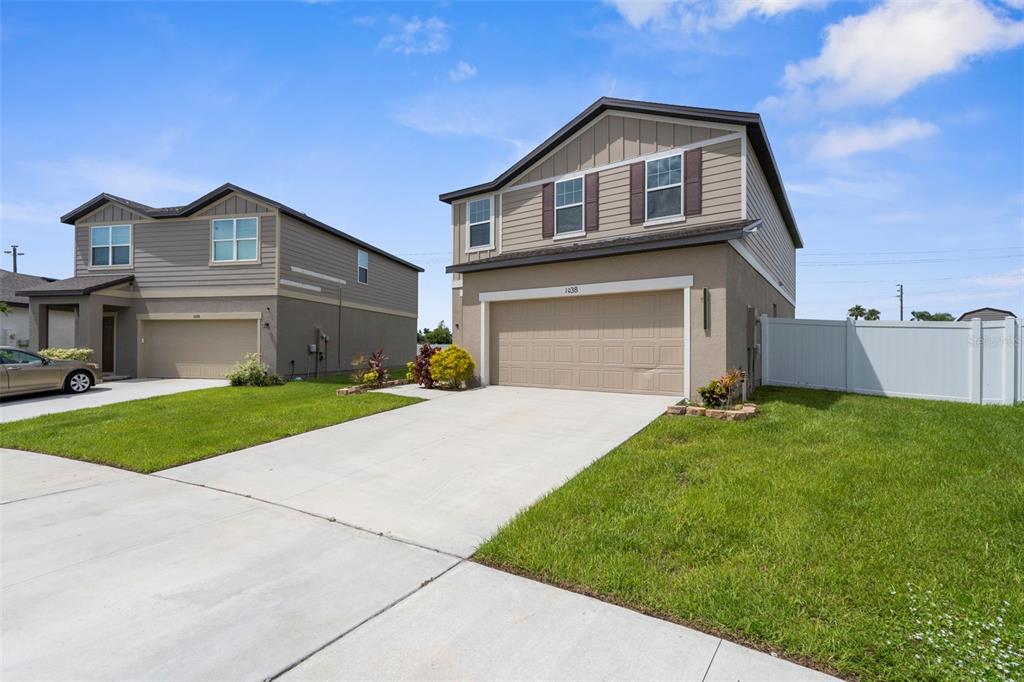 1038 Kelly Fern Loop Ruskin, FL 33570 - Photo 3 of 34 a front view of a house with a yard and garage