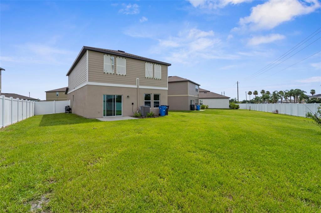 1038 Kelly Fern Loop Ruskin, FL 33570 - Photo 33 of 34 a view of a house with a big yard and large trees