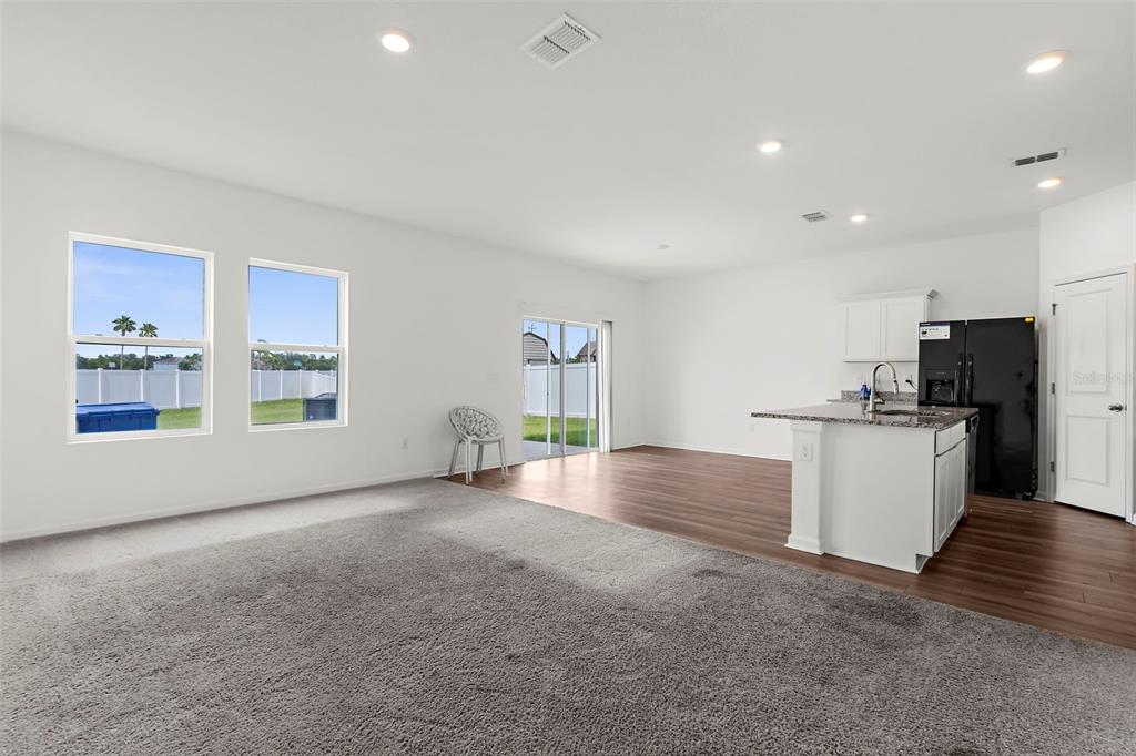 1038 Kelly Fern Loop Ruskin, FL 33570 - Photo 4 of 34 a view of an empty room with kitchen and window