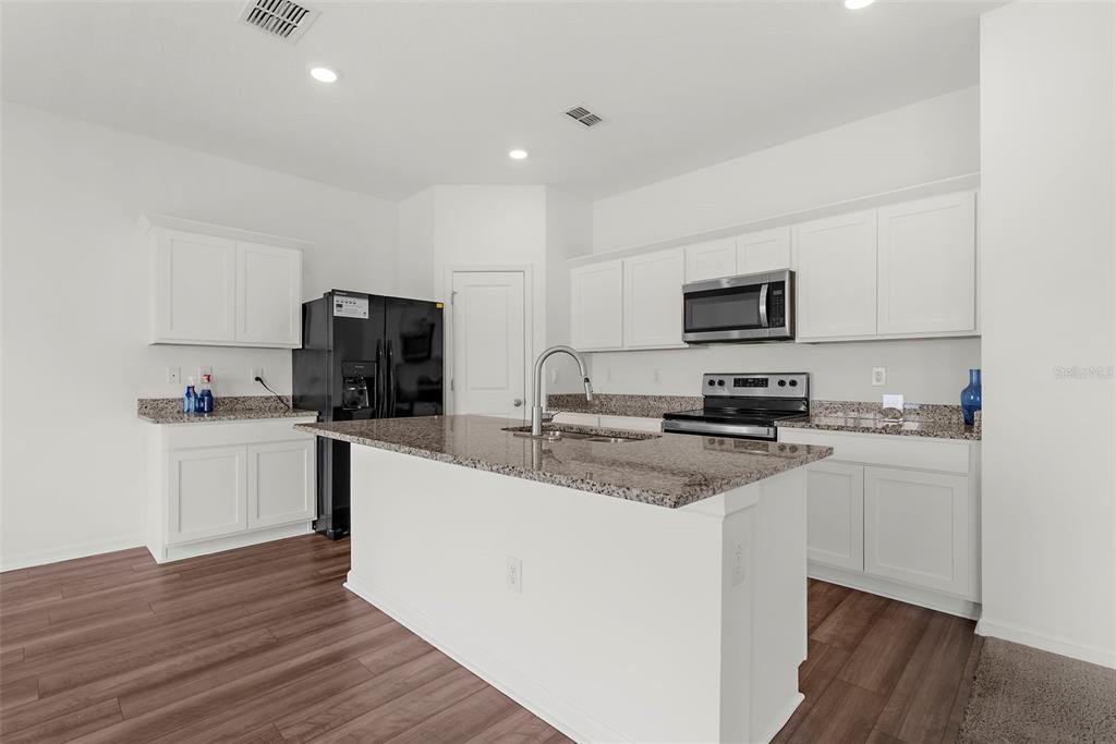 1038 Kelly Fern Loop Ruskin, FL 33570 - Photo 6 of 34 a kitchen with appliances a sink and cabinets