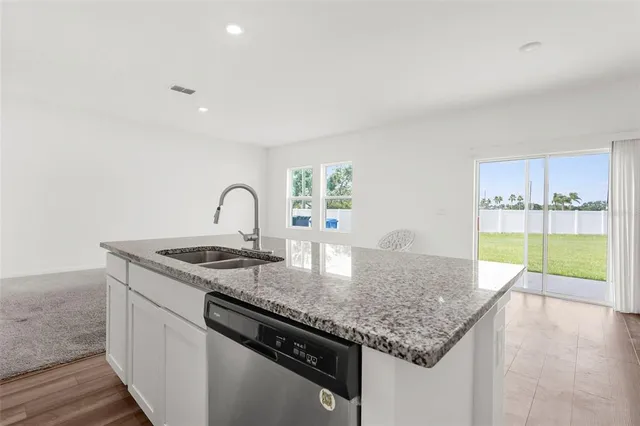 a kitchen with a sink and a stove top oven