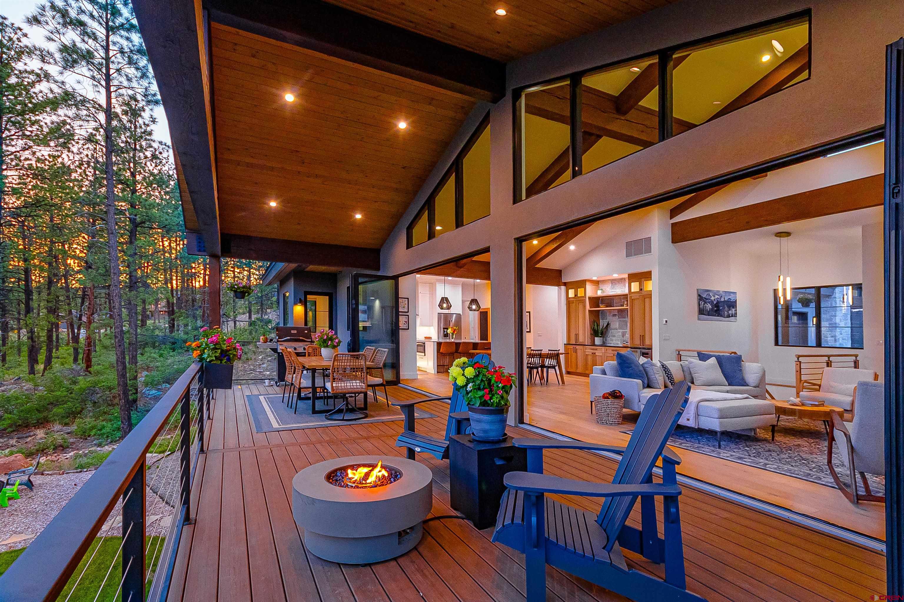a view of a patio with table and chairs potted plants with wooden floor and fence