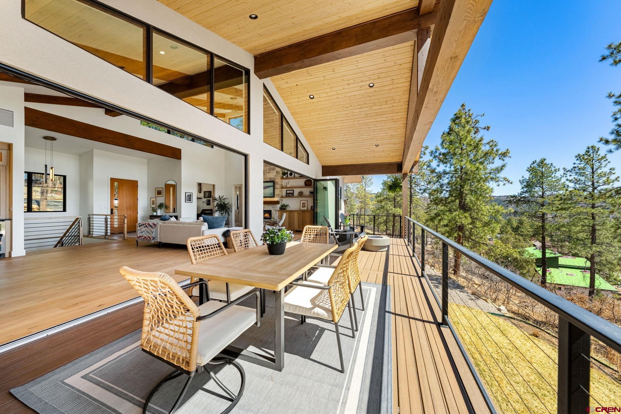 26 Boulder View Drive Durango, CO 81301 - Photo 19 of 45 a view of a balcony with chairs and wooden floor