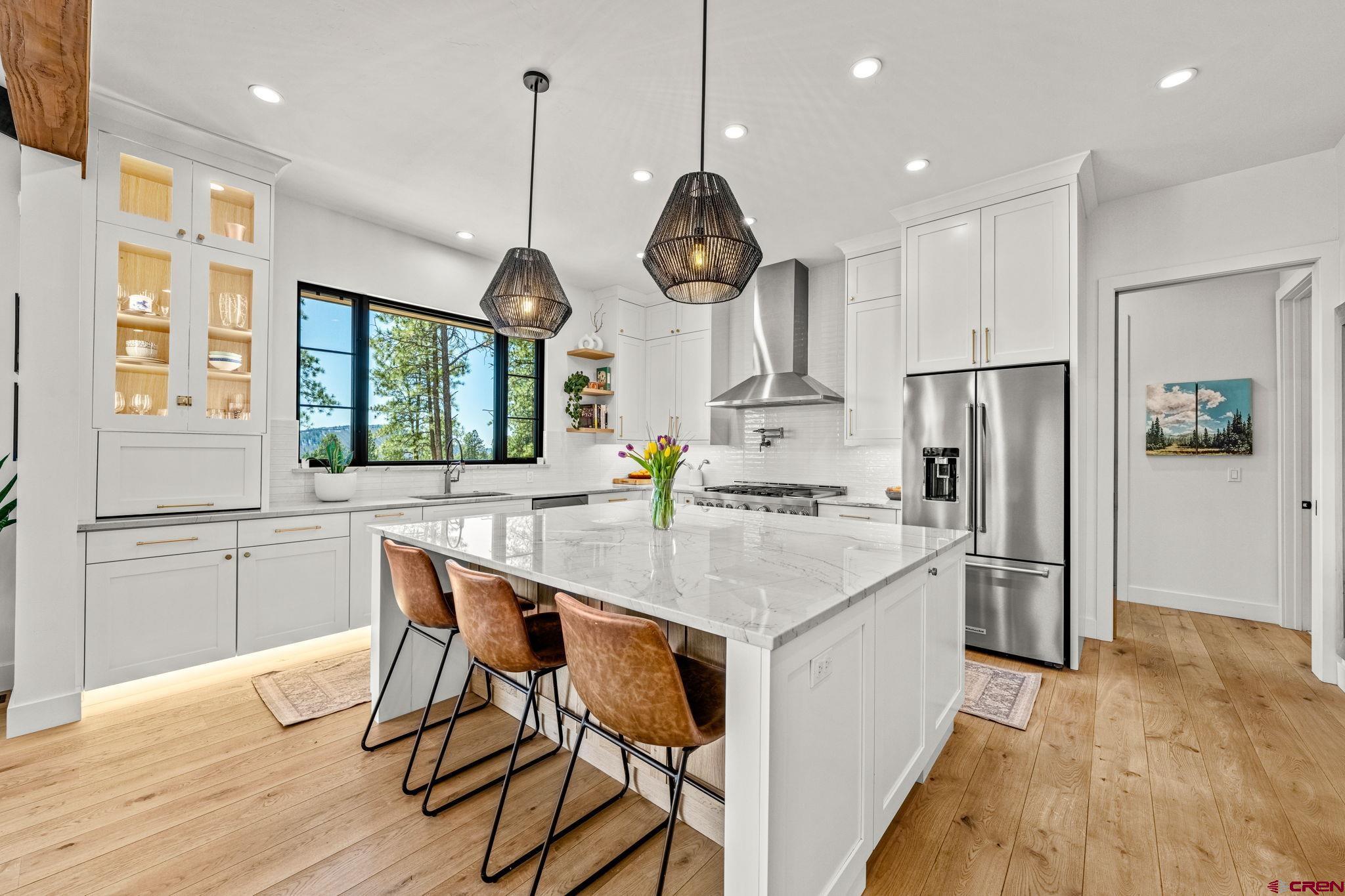 26 Boulder View Drive Durango, CO 81301 - Photo 20 of 45 a kitchen with stainless steel appliances granite countertop a stove refrigerator and wooden floor