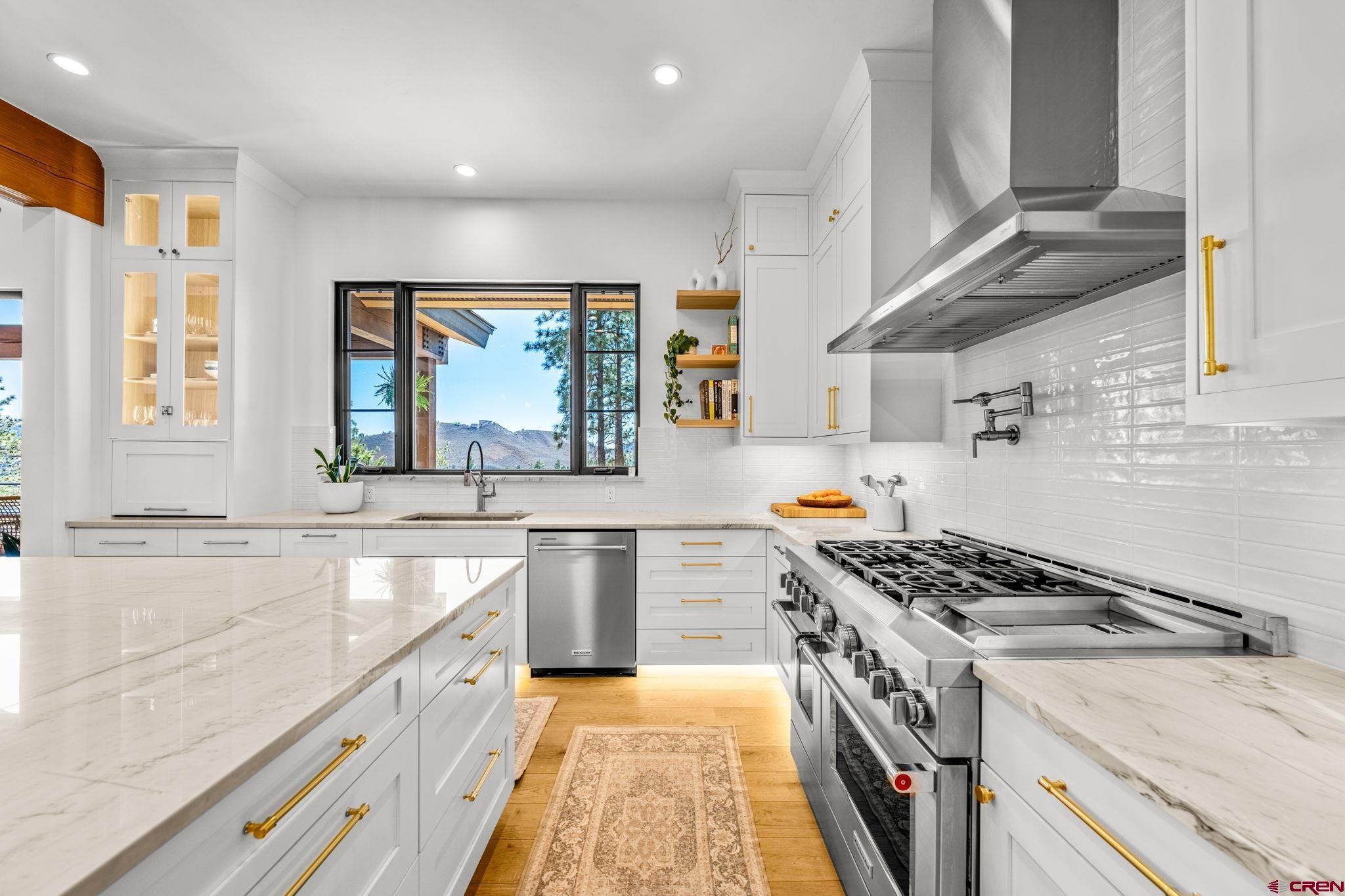 26 Boulder View Drive Durango, CO 81301 - Photo 21 of 45 a kitchen with granite countertop a stove and a sink