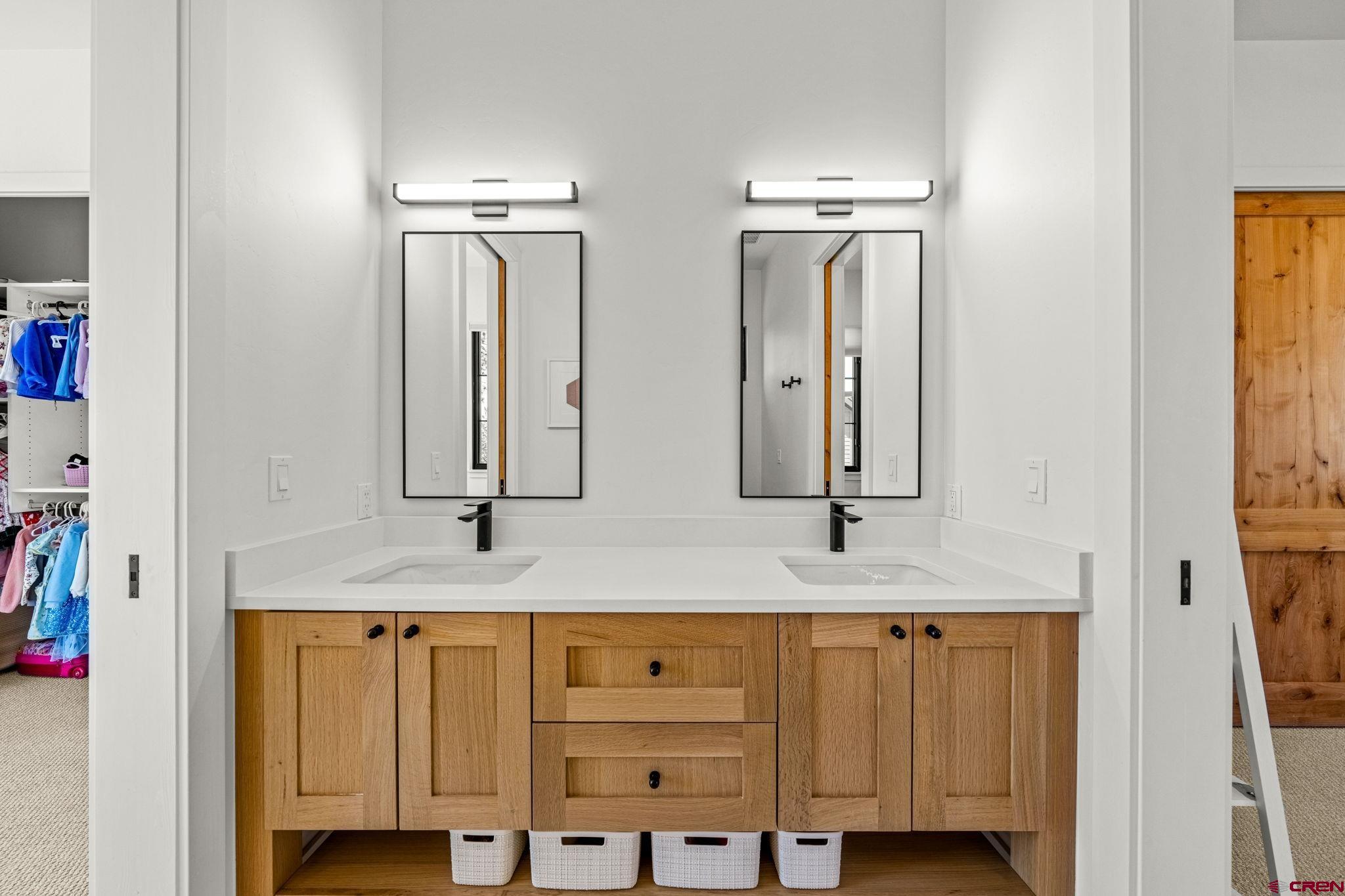 26 Boulder View Drive Durango, CO 81301 - Photo 33 of 45 a bathroom with double vanity and a mirror