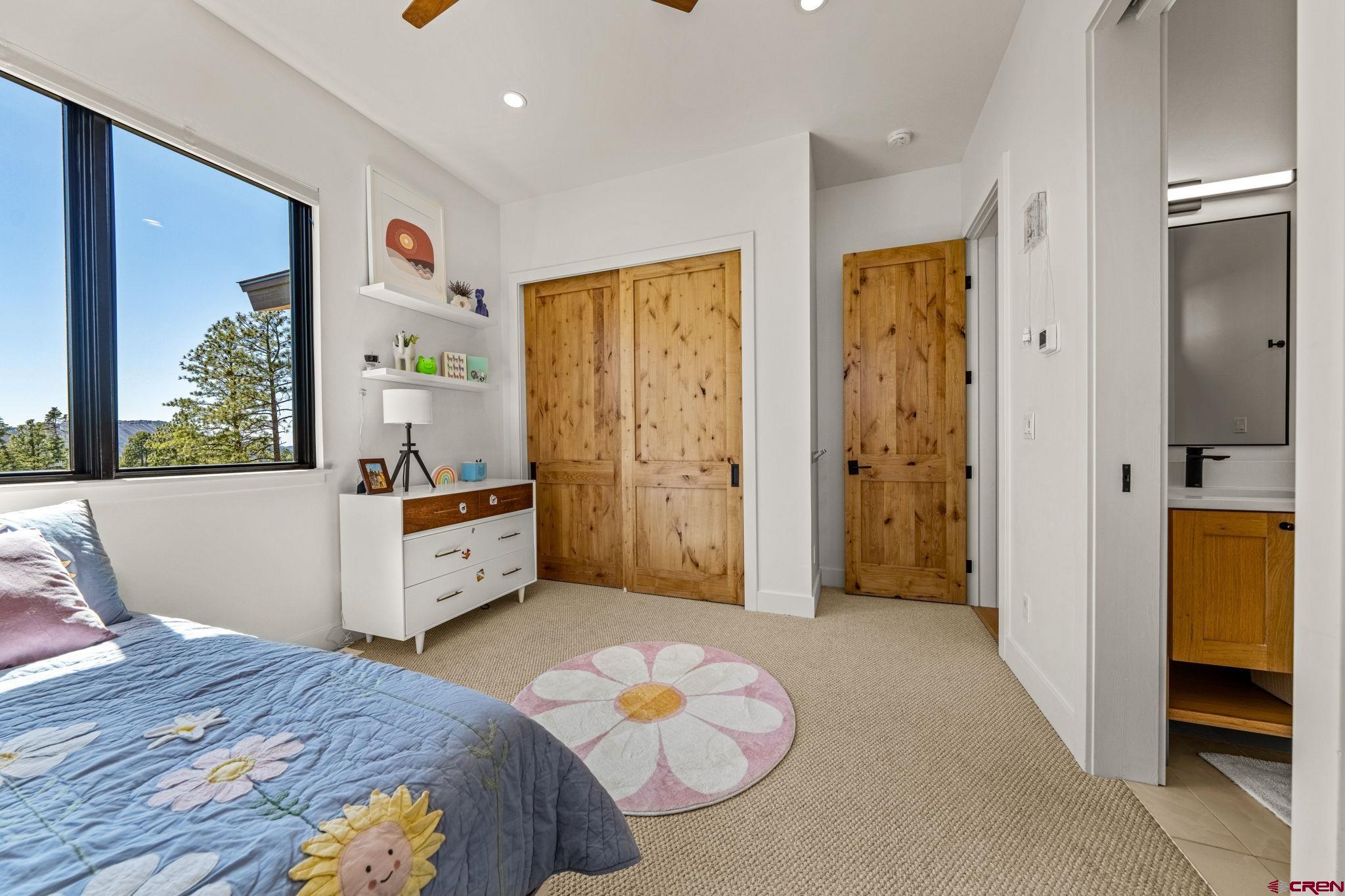 26 Boulder View Drive Durango, CO 81301 - Photo 36 of 45 a bedroom with a bed and wooden floor