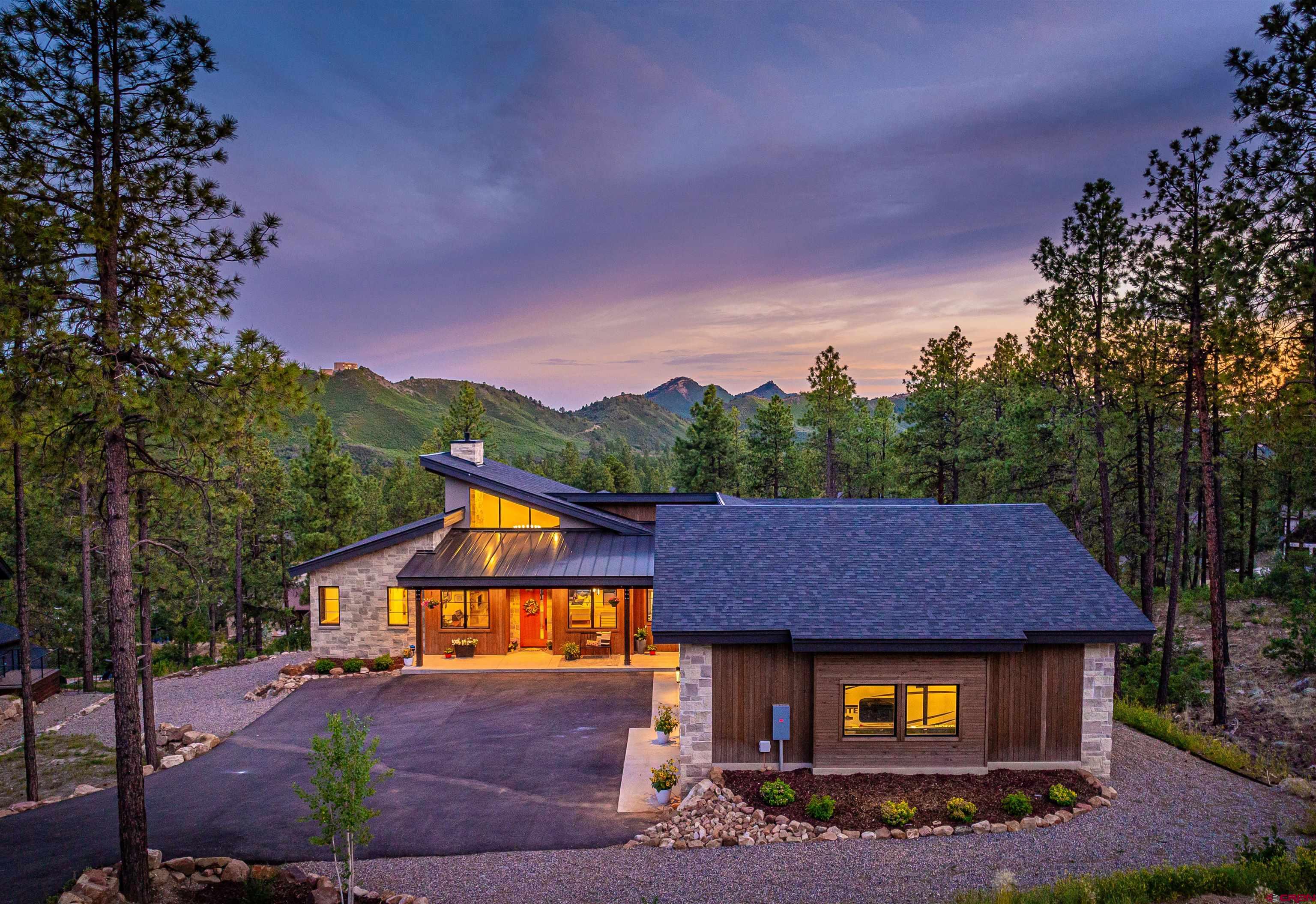 26 Boulder View Drive Durango, CO 81301 - Photo 4 of 45 a view of a big house with a big yard and large trees