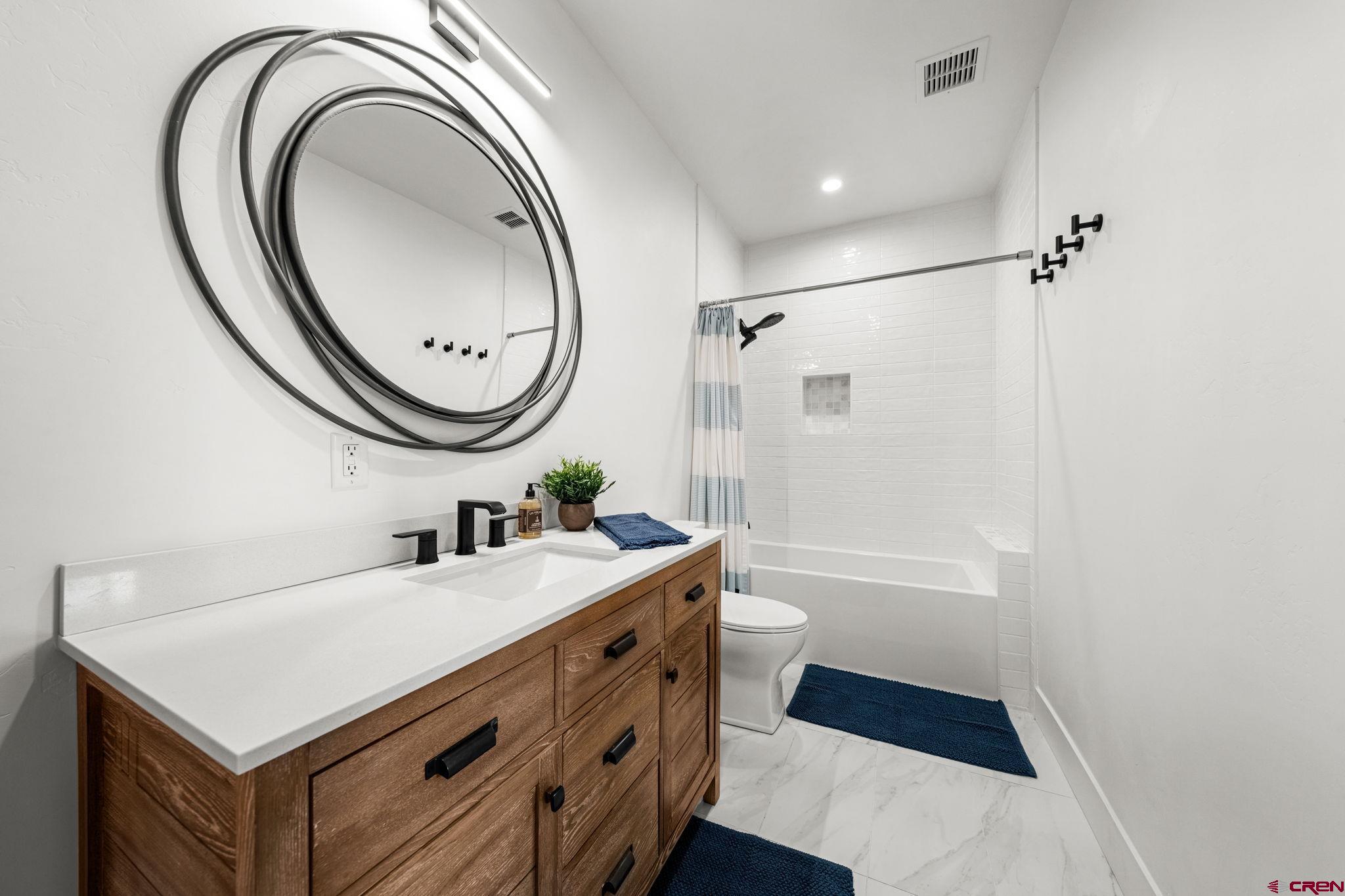 26 Boulder View Drive Durango, CO 81301 - Photo 41 of 45 a bathroom with a sink a toilet and a mirror