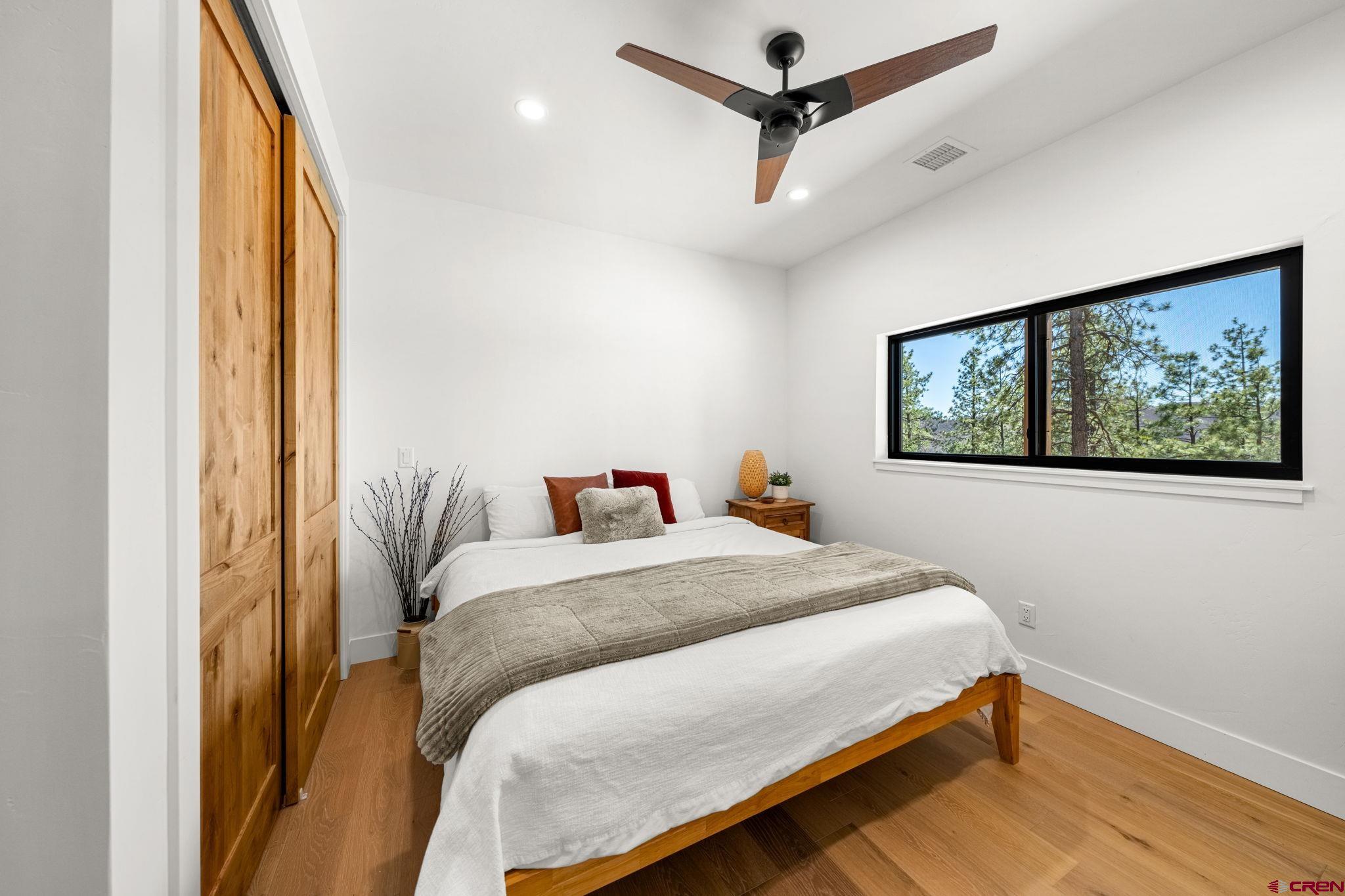 26 Boulder View Drive Durango, CO 81301 - Photo 42 of 45 a bedroom with a bed and a painting on the wall