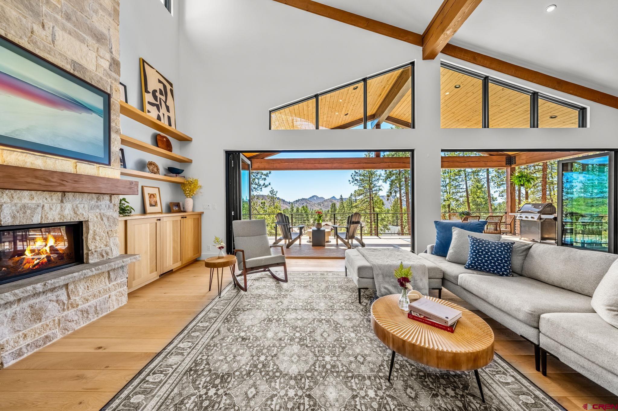 26 Boulder View Drive Durango, CO 81301 - Photo 8 of 45 a living room with furniture a fireplace and a flat screen tv