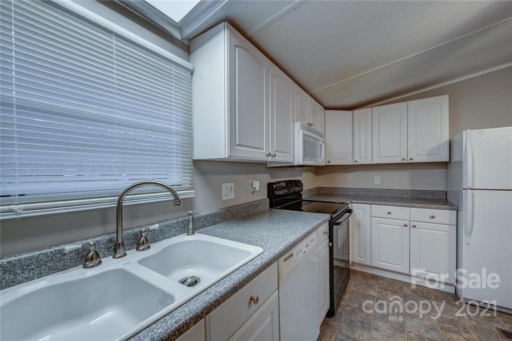 1349 Sherwood Road Clover, SC 29710 - Photo 11 of 23 a kitchen with stainless steel appliances granite countertop a sink stove and cabinets
