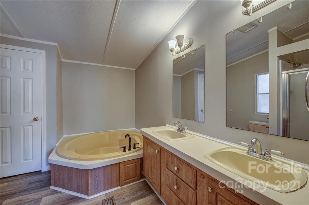 1349 Sherwood Road Clover, SC 29710 - Photo 14 of 23 a bathroom with a granite countertop sink mirror and bathtub