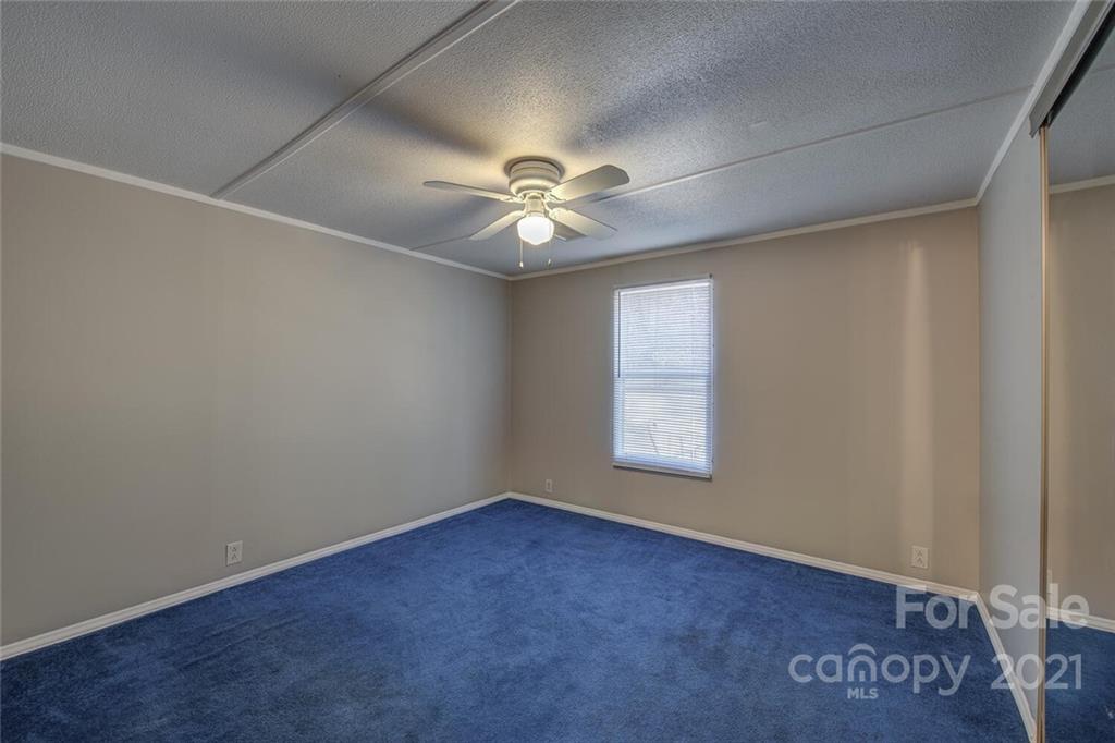 1349 Sherwood Road Clover, SC 29710 - Photo 15 of 23 an empty room with windows and chandelier fan