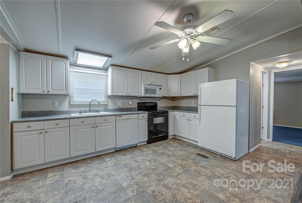1349 Sherwood Road Clover, SC 29710 - Photo 9 of 23 a kitchen with a refrigerator a sink and cabinets