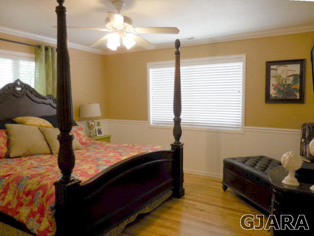 3581 G Road Palisade, CO 81526 - Photo 12 of 41 a bedroom with a bed and a chandelier
