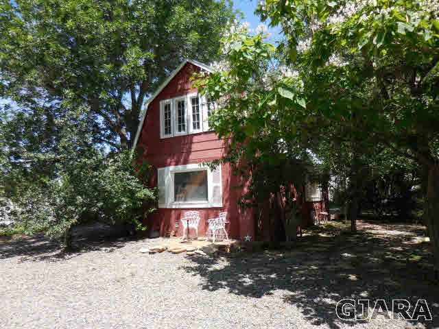 3581 G Road Palisade, CO 81526 - Photo 17 of 41 a front view of a house with a yard
