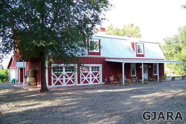 3581 G Road Palisade, CO 81526 - Photo 20 of 41 a view of a cafe with table and chairs and a large tree