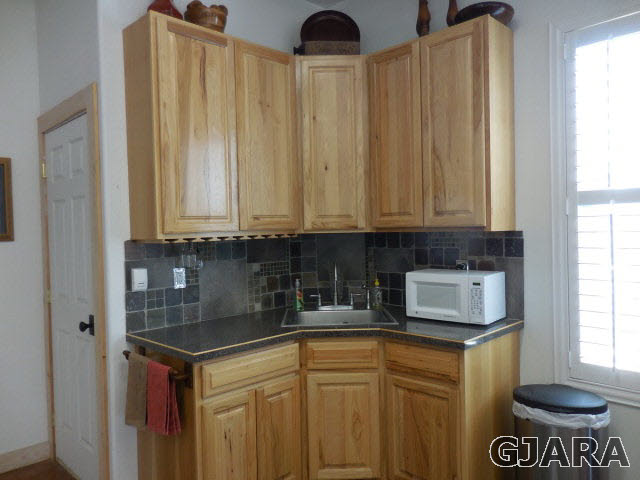 3581 G Road Palisade, CO 81526 - Photo 25 of 41 a kitchen with stainless steel appliances granite countertop a stove a sink and a microwave