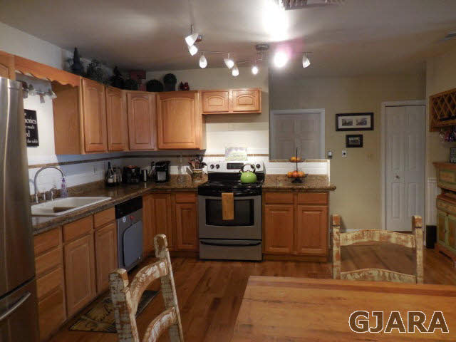 3581 G Road Palisade, CO 81526 - Photo 8 of 41 a kitchen with kitchen island granite countertop a sink cabinets and stainless steel appliances