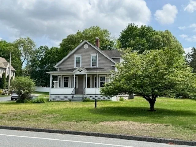 a front view of a house with a garden