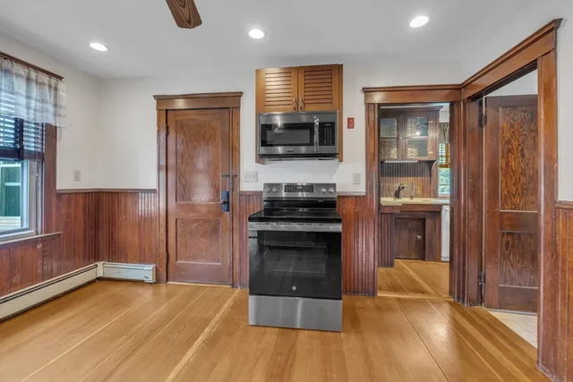a kitchen with stainless steel appliances granite countertop a refrigerator and a stove top oven