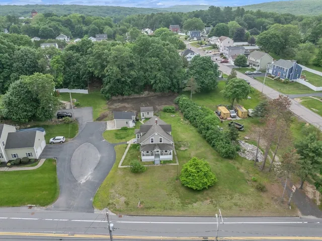 an aerial view of a house with garden space and lake view