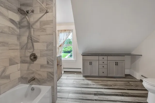 a view of a room with wooden floor and window