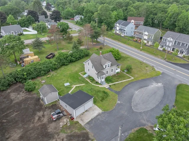 an aerial view of a house with a yard