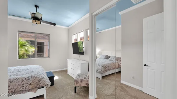 a bedroom with a bed and a chandelier