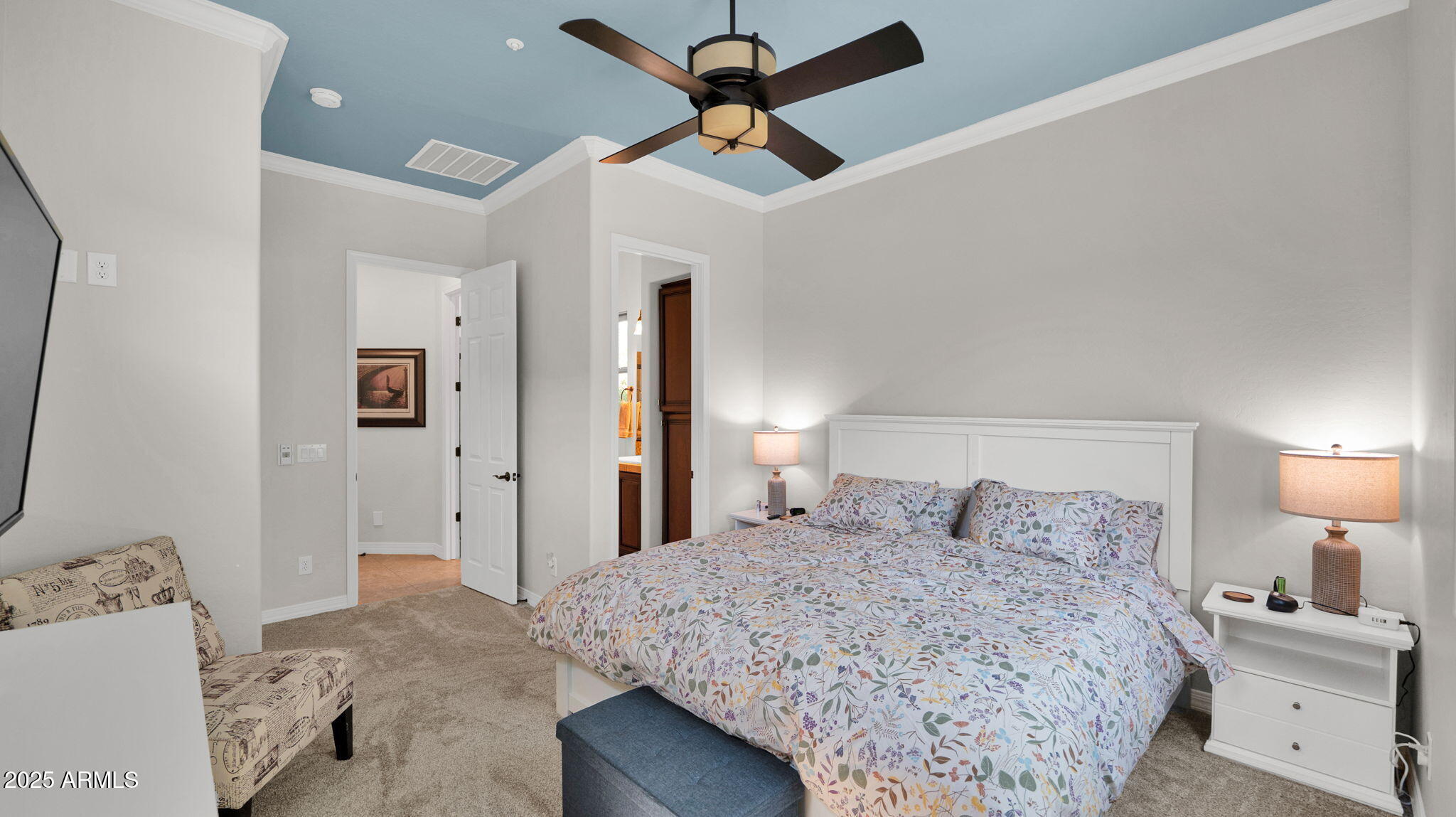 12981 West Yellow Bird Lane Peoria, AZ 85383 - Photo 17 of 47 a bedroom with a bed and a chandelier