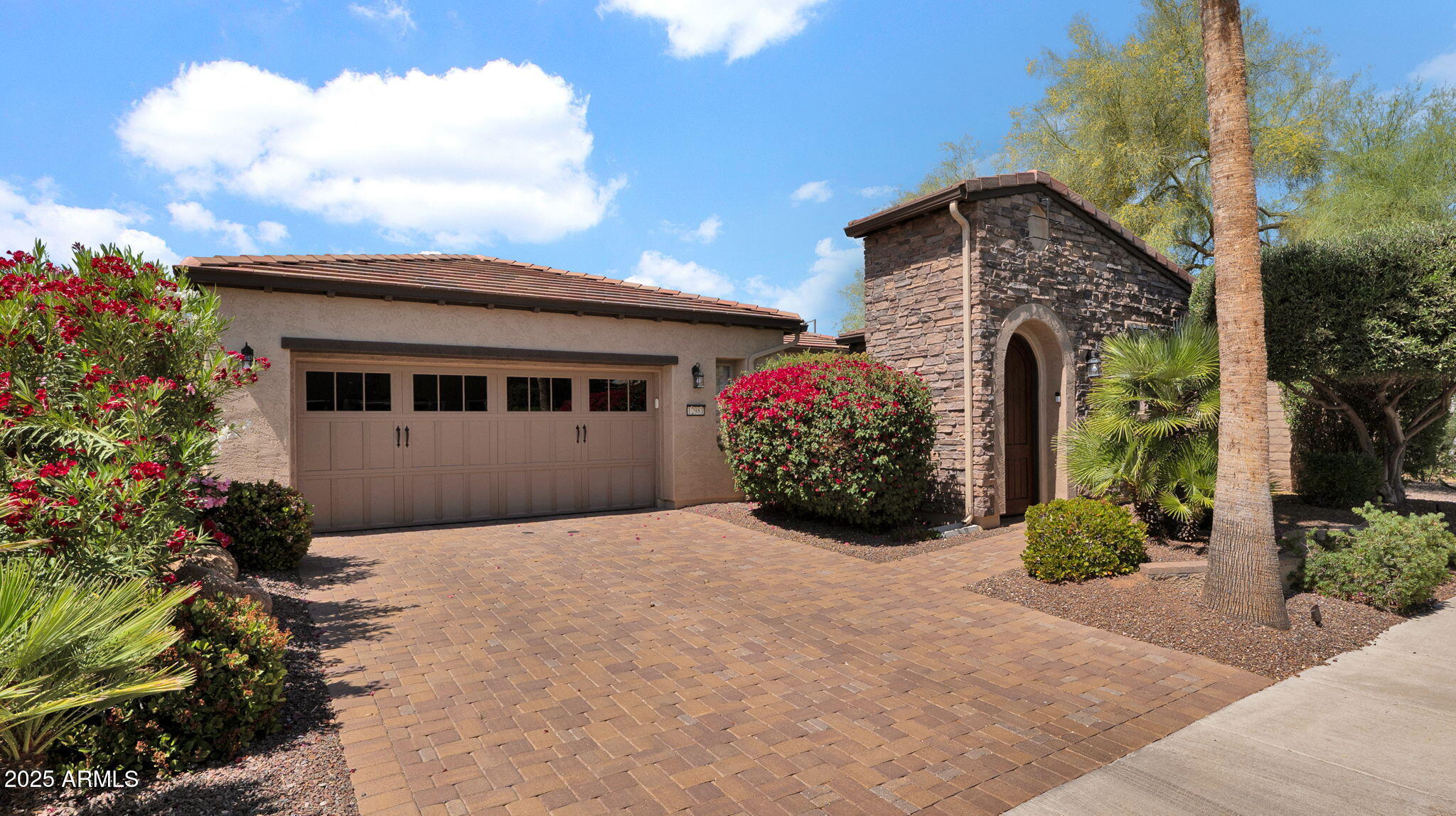 12981 West Yellow Bird Lane Peoria, AZ 85383 - Photo 2 of 47 a front view of a house with garden