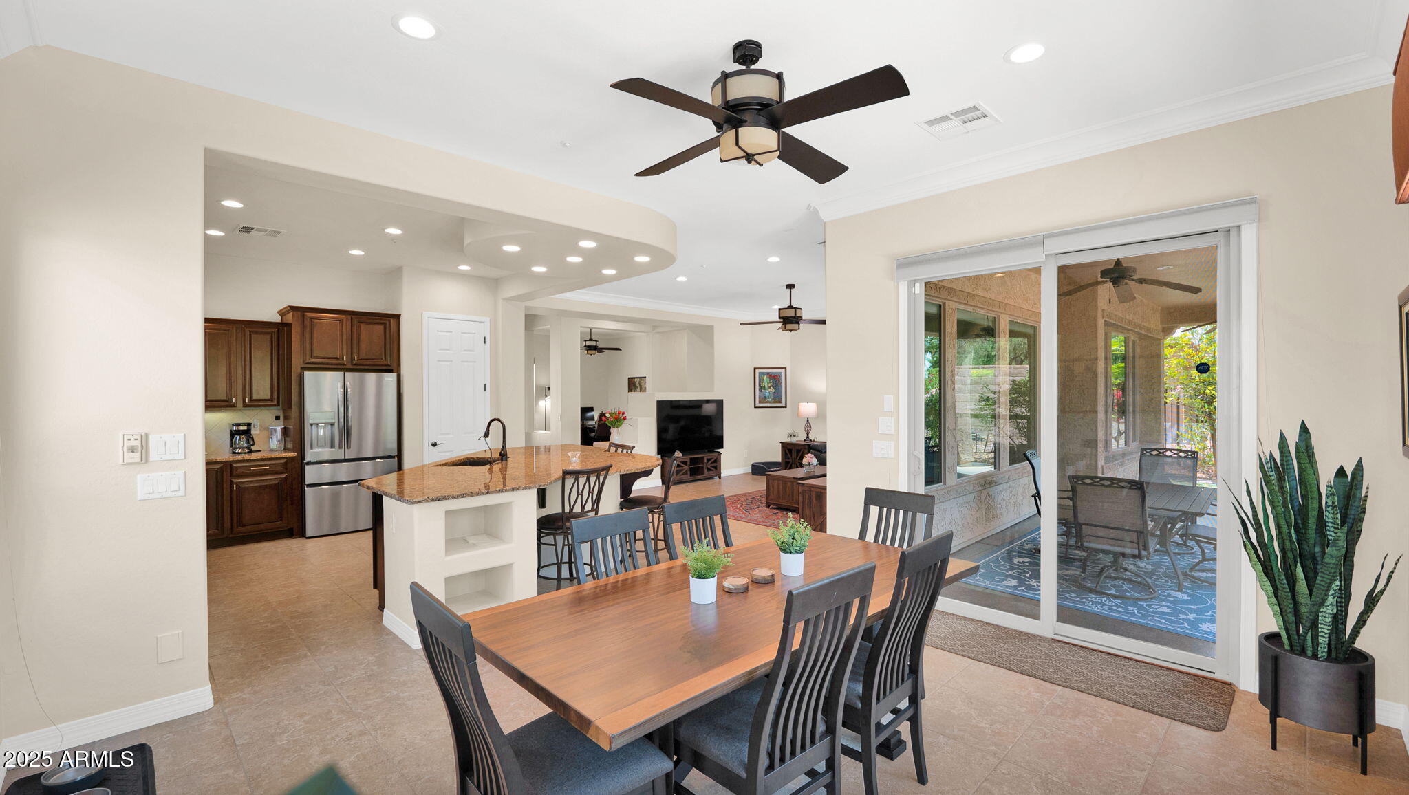 12981 West Yellow Bird Lane Peoria, AZ 85383 - Photo 29 of 47 a dining room with furniture a floor to ceiling window and a potted plant