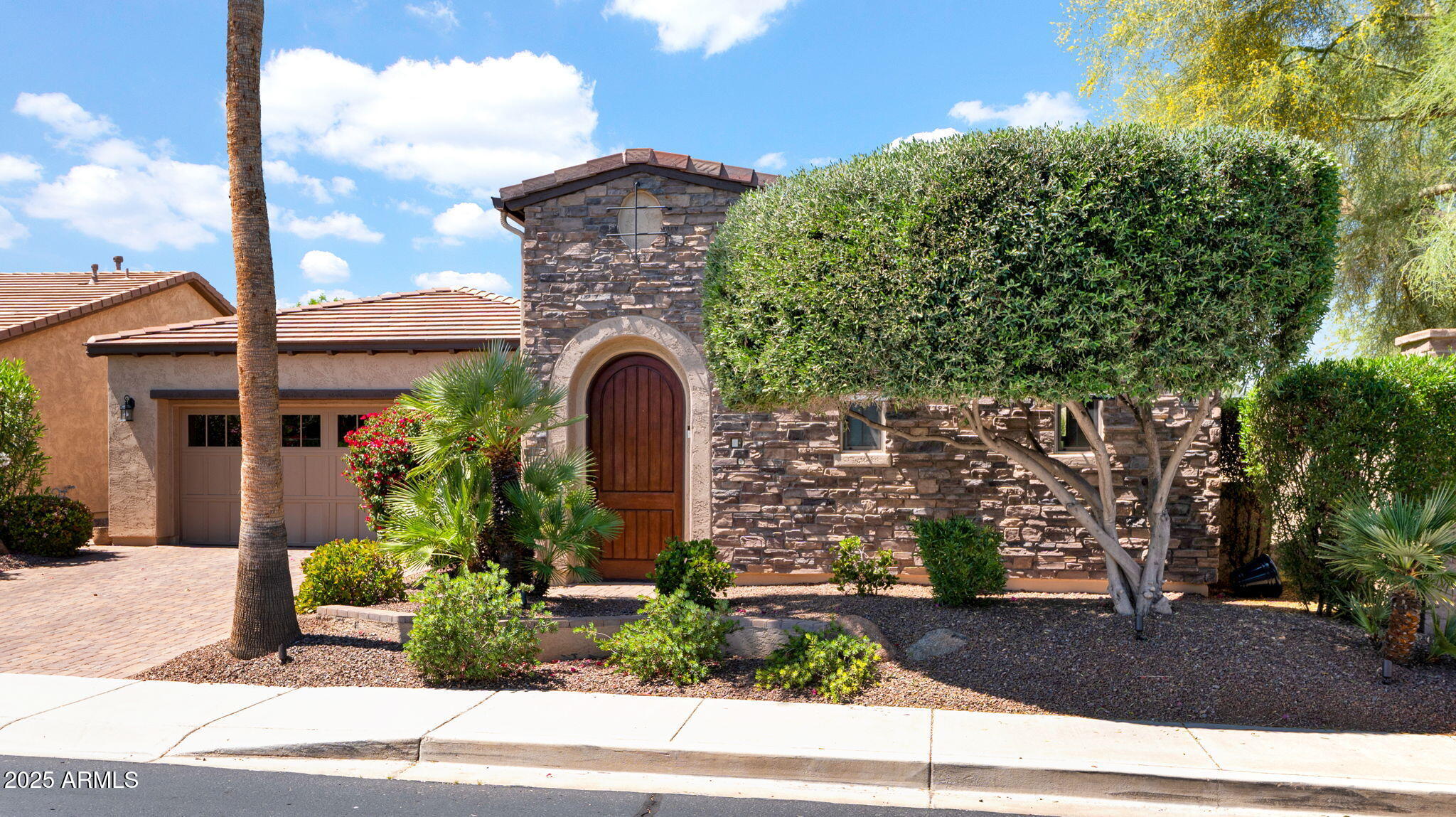 12981 West Yellow Bird Lane Peoria, AZ 85383 - Photo 3 of 47 a front view of a house with garden