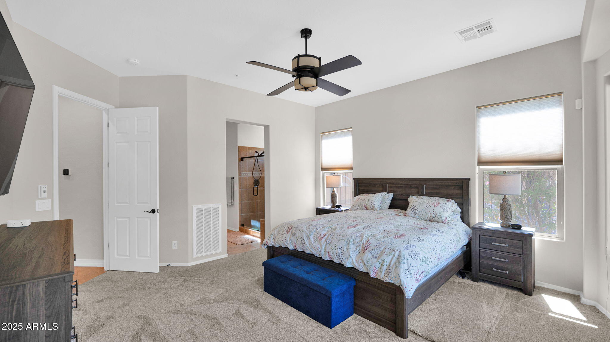 12981 West Yellow Bird Lane Peoria, AZ 85383 - Photo 31 of 47 a bedroom with a bed and a chandelier
