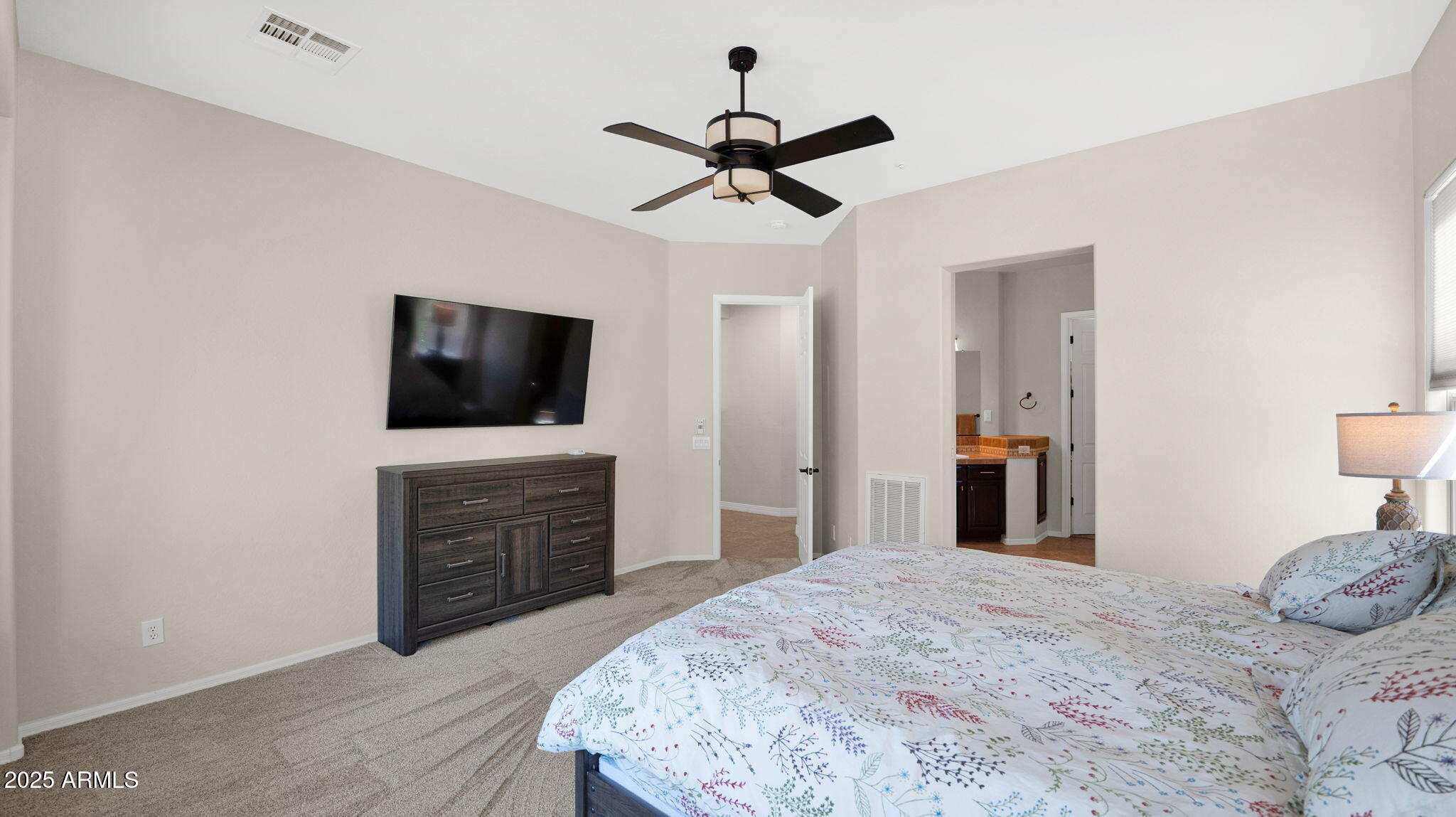 12981 West Yellow Bird Lane Peoria, AZ 85383 - Photo 32 of 47 a bedroom with a bed and a flat screen tv