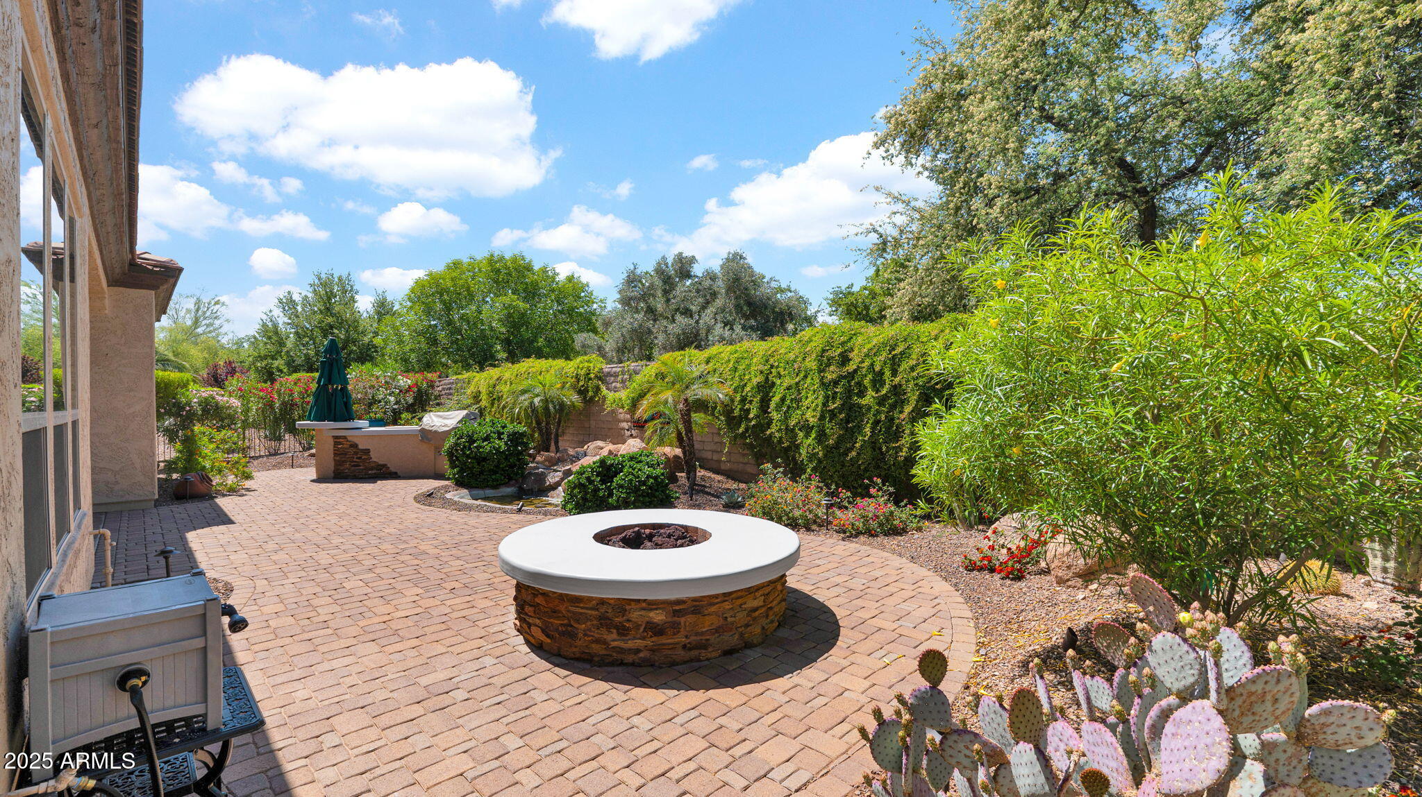 12981 West Yellow Bird Lane Peoria, AZ 85383 - Photo 42 of 47 a view of a backyard with table and chairs potted plants and palm tree