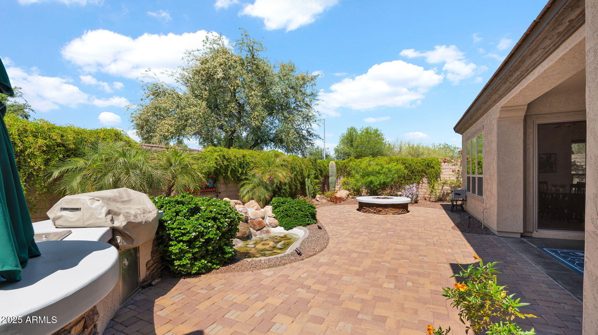 12981 West Yellow Bird Lane Peoria, AZ 85383 - Photo 43 of 47 a view of a backyard with sitting area and garden