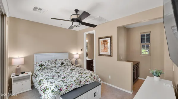 a bedroom with a large bed and a chandelier