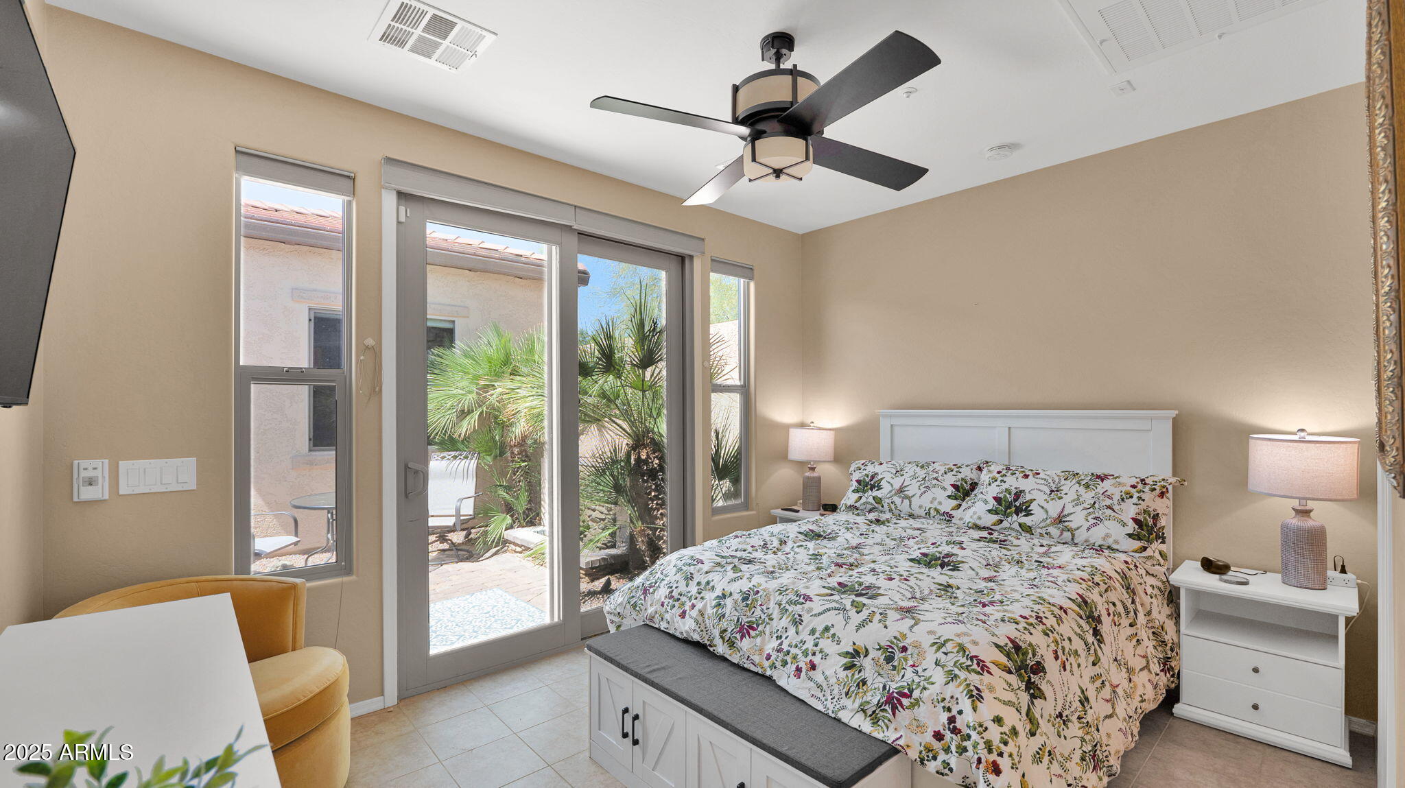 12981 West Yellow Bird Lane Peoria, AZ 85383 - Photo 9 of 47 a bedroom with a large bed and a large window