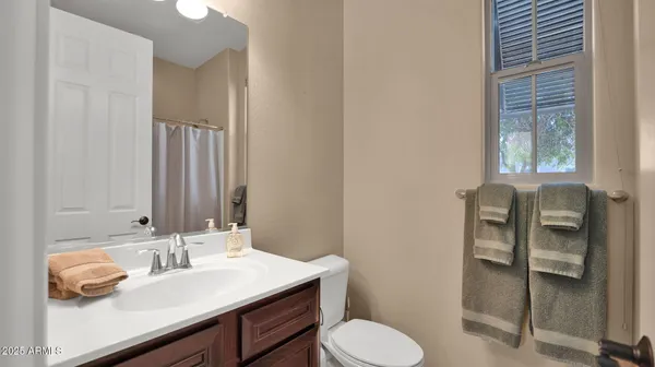 a bathroom with a sink vanity and toilet