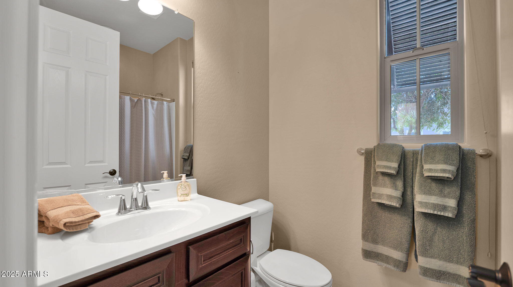 12981 West Yellow Bird Lane Peoria, AZ 85383 - Photo 10 of 47 a bathroom with a sink vanity and toilet