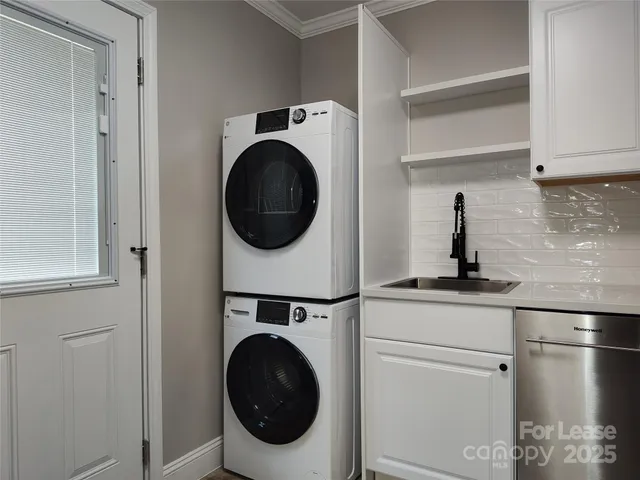 a utility room with sink dryer and washer