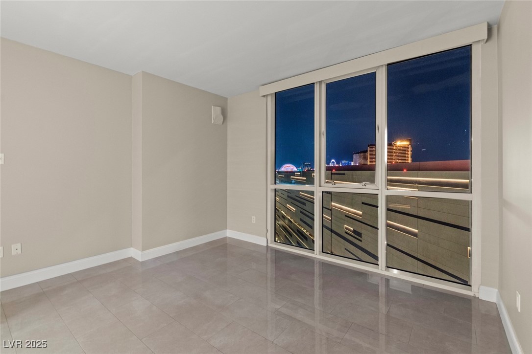 2747 Paradise Road, Unit 2206 Las Vegas, NV 89109 - Photo 12 of 15 Spare room with tile patterned floors and baseboards