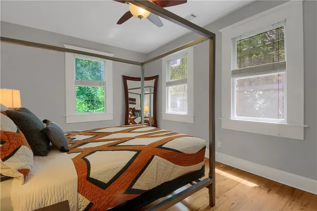 a bathroom with a granite countertop sink toilet a mirror and shower