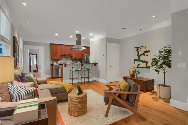 a living room with furniture and a potted plant